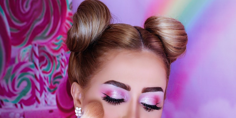 Women applying makeup on her face