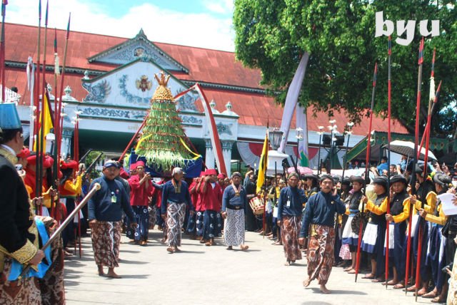 Para abdi dalem keraton sedang memikul gunungan