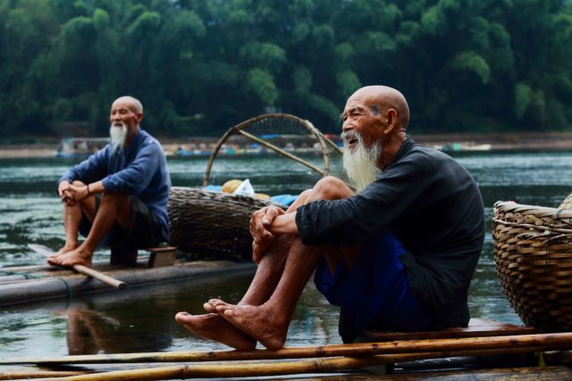 chatting with two men on riverbank
